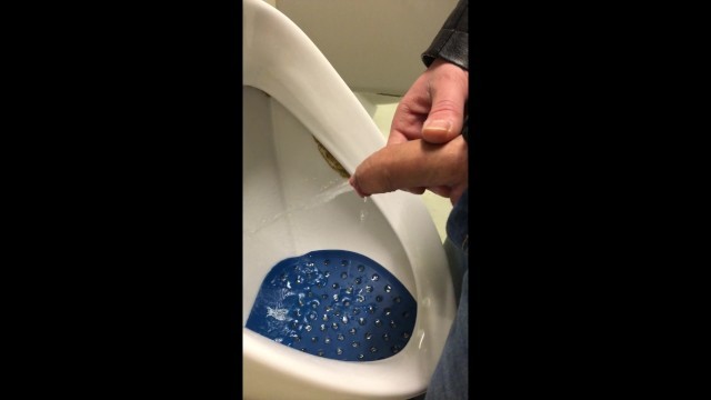 dirty boy pissing in dirty urinal
